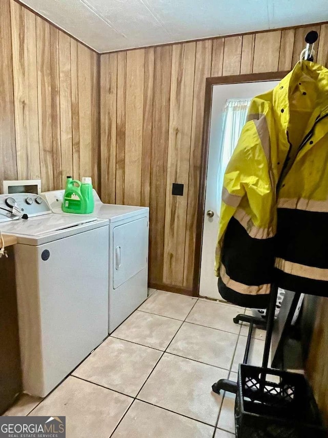 207 Timothy Ct, Vidalia, GA 30474 - washroom with washing machine and dryer, wood walls, and light tile patterned flooring