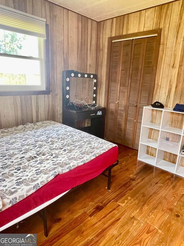 207 Timothy Ct, Vidalia, GA 30474 - bedroom with wooden walls, wood finished floors, and a closet