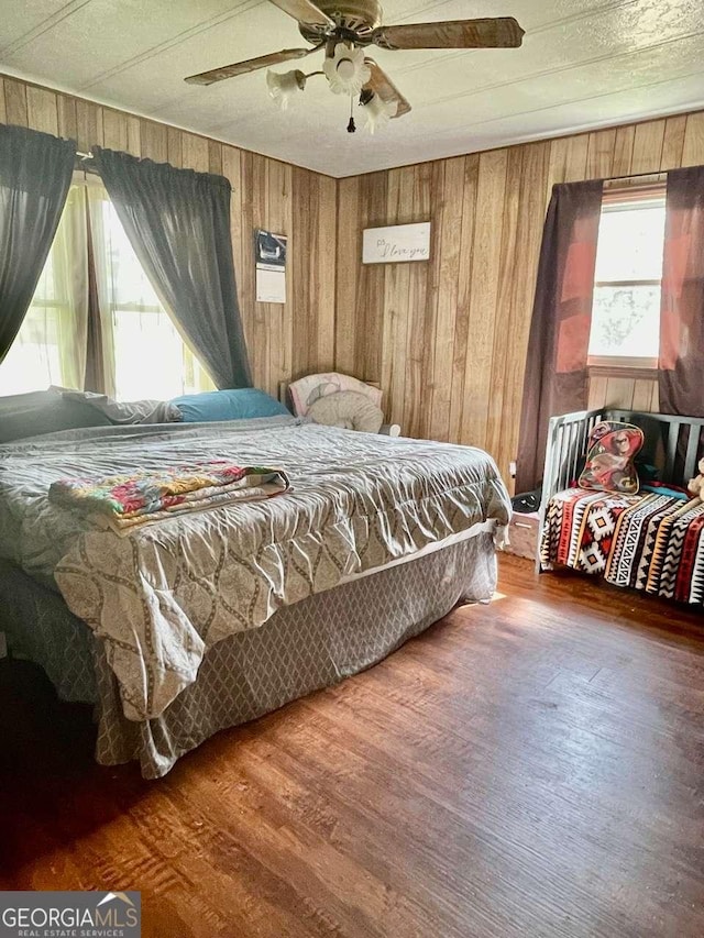 207 Timothy Ct, Vidalia, GA 30474 - bedroom featuring wood finished floors, wood walls, and a ceiling fan