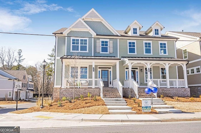 164 Palm St, Holly Springs, GA 30188 - view of property with a porch, a standing seam roof, and a metal roof