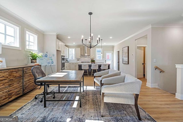 164 Palm St, Holly Springs, GA 30188 - dining space with light wood-style flooring, a chandelier, ornamental molding, and recessed lighting