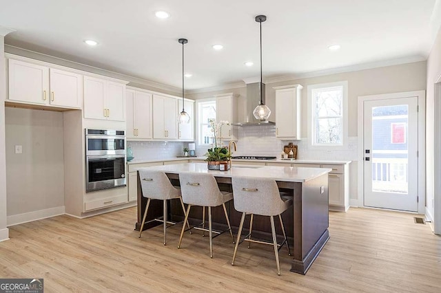 164 Palm St, Holly Springs, GA 30188 - kitchen featuring stainless steel double oven, wall chimney exhaust hood, ornamental molding, decorative backsplash, and light countertops