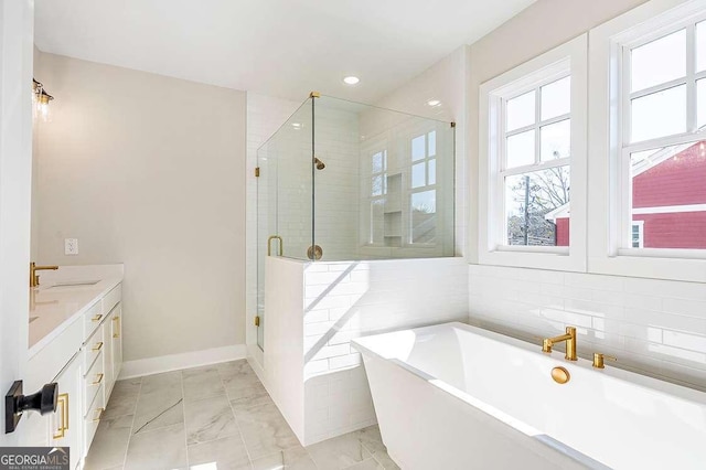 164 Palm St, Holly Springs, GA 30188 - full bathroom featuring a freestanding bath, a shower stall, double vanity, marble look tile flooring, and recessed lighting