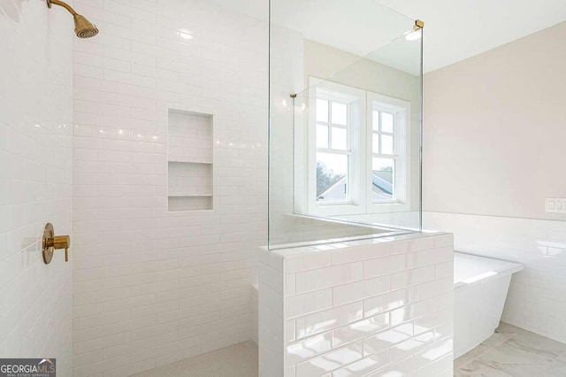 164 Palm St, Holly Springs, GA 30188 - full bath featuring tile walls, walk in shower, marble look tiles, a freestanding tub, and wainscoting