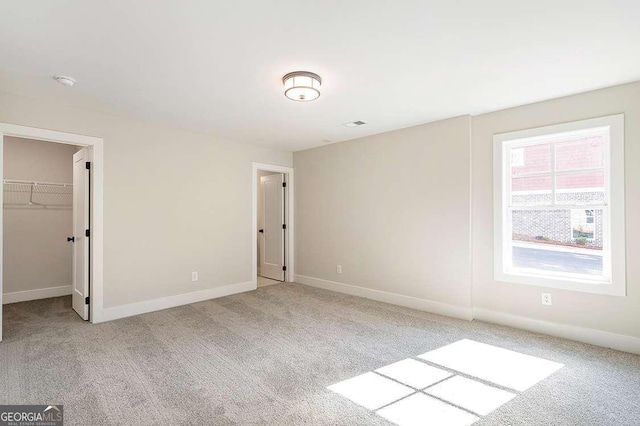 164 Palm St, Holly Springs, GA 30188 - unfurnished bedroom with carpet floors and a walk in closet