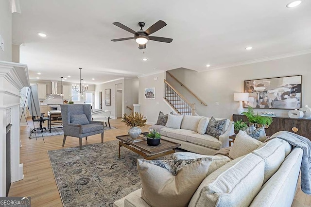 164 Palm St, Holly Springs, GA 30188 - living room with recessed lighting, stairway, ornamental molding, ceiling fan, and light wood-style floors