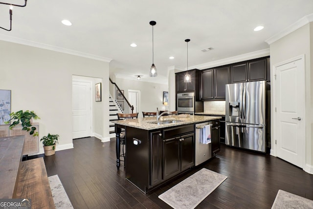 5640 Hammock Way, Cumming, GA 30028 - kitchen with stainless steel appliances, crown molding, a center island with sink, light stone countertops, and recessed lighting