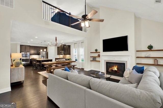 5640 Hammock Way, Cumming, GA 30028 - living area with ceiling fan, a glass covered fireplace, a high ceiling, recessed lighting, and dark wood-style floors