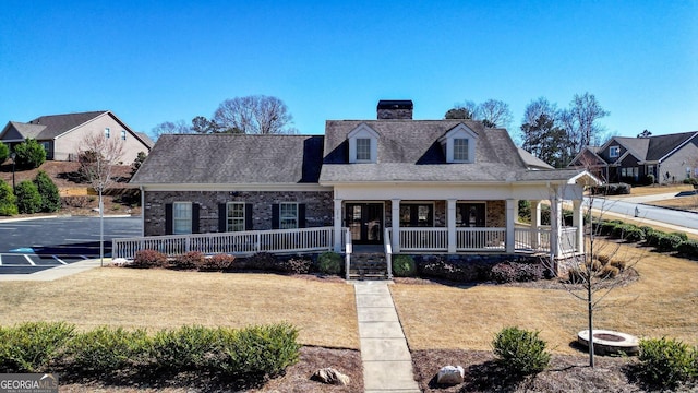 5640 Hammock Way, Cumming, GA 30028 - view of front of property featuring a porch, a chimney, brick siding, and a front yard