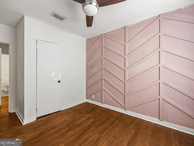 805 First Ave, Brunswick, GA 31520 - unfurnished bedroom featuring dark wood-type flooring and baseboards