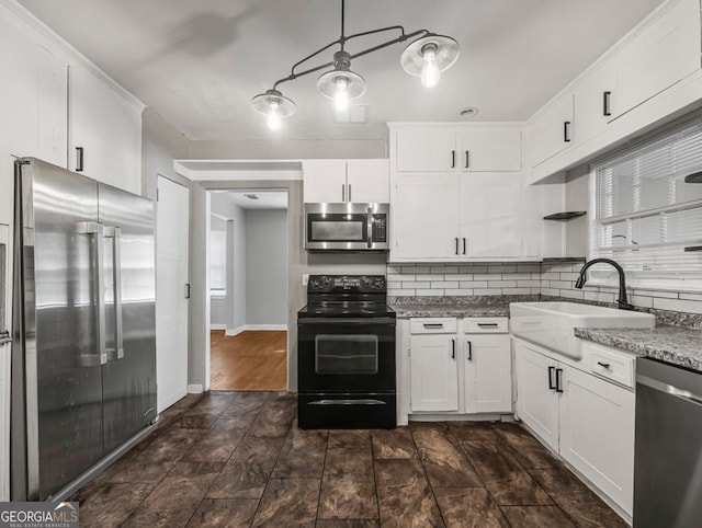 805 First Ave, Brunswick, GA 31520 - kitchen featuring stainless steel appliances, backsplash, white cabinets, and light stone counters