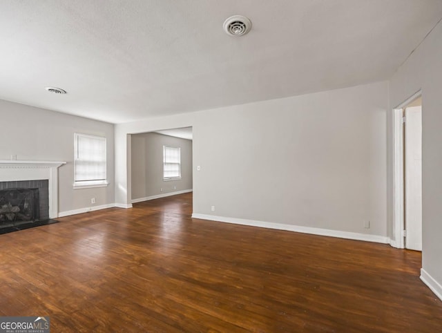 805 First Ave, Brunswick, GA 31520 - unfurnished living room featuring a brick fireplace and wood finished floors