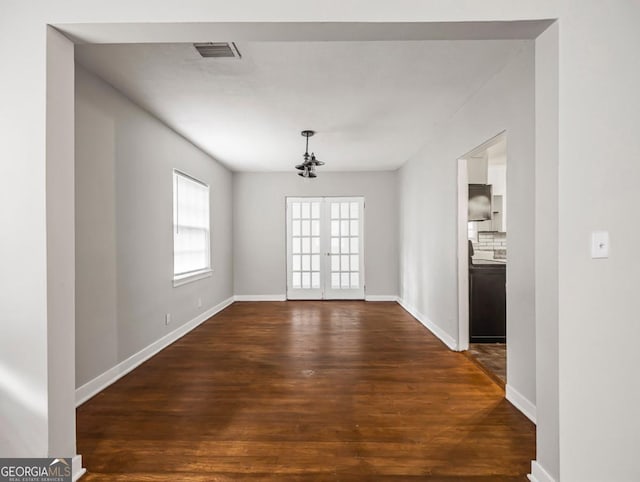 805 First Ave, Brunswick, GA 31520 - unfurnished dining area featuring dark wood finished floors and french doors