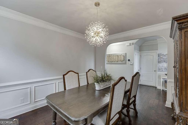 1830 Secretariat Gait Way, Suwanee, GA 30024 - dining space featuring arched walkways, a chandelier, dark wood finished floors, crown molding, and a decorative wall