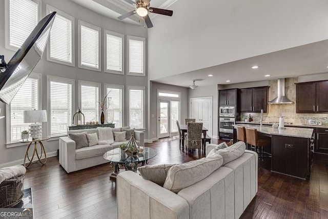 1830 Secretariat Gait Way, Suwanee, GA 30024 - living room featuring dark wood-style floors, a ceiling fan, a high ceiling, and recessed lighting