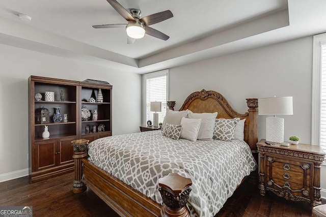 1830 Secretariat Gait Way, Suwanee, GA 30024 - bedroom with dark wood-style flooring, ceiling fan, and a tray ceiling