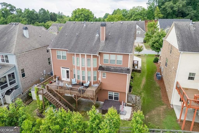 1830 Secretariat Gait Way, Suwanee, GA 30024 - rear view of property with a chimney, a deck, a hot tub, a residential view, and a fenced backyard