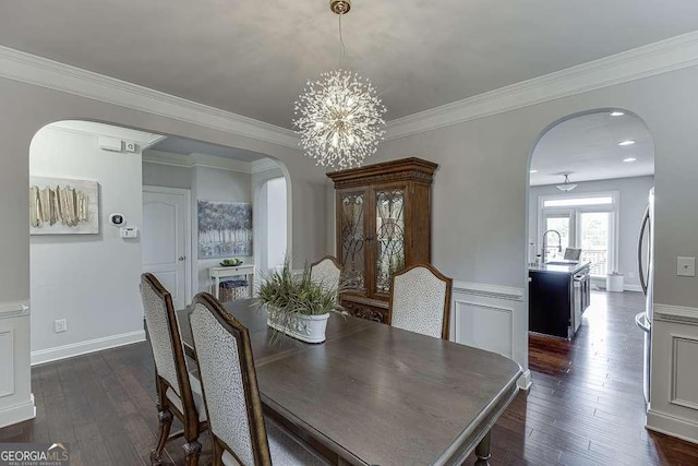 1830 Secretariat Gait Way, Suwanee, GA 30024 - dining space with arched walkways, dark wood-style flooring, a chandelier, and ornamental molding