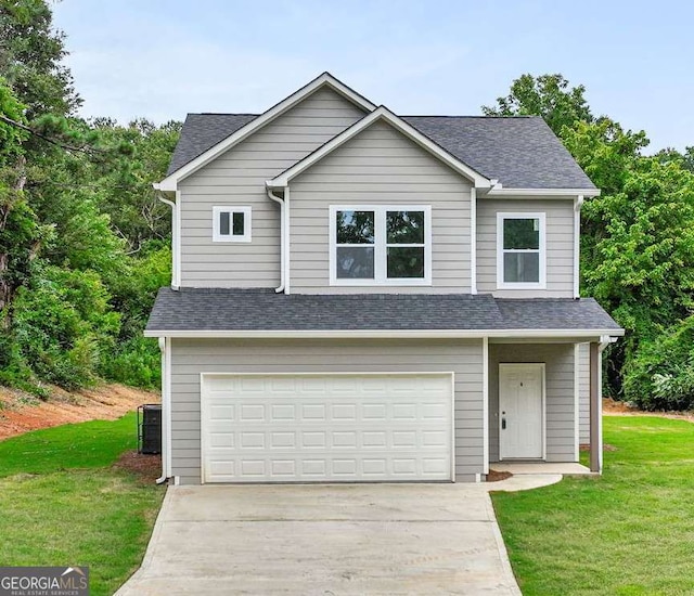 307 E Pine St E, Rockmart, GA 30153 - traditional-style home featuring concrete driveway, a garage, roof with shingles, and a front lawn