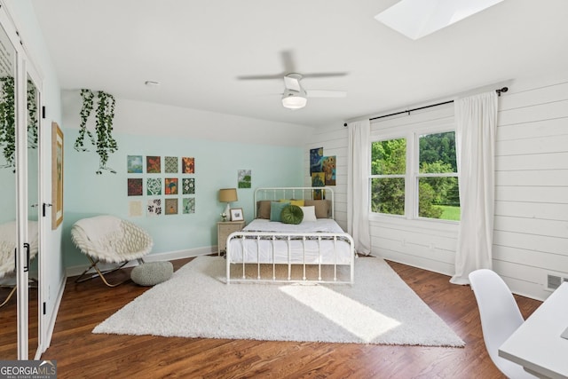 5095 Karr Rd, Cumming, GA 30040 - bedroom featuring wood finished floors, a skylight, ceiling fan, and wooden walls