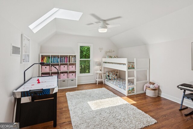 5095 Karr Rd, Cumming, GA 30040 - bedroom featuring a skylight, lofted ceiling, wood finished floors, and a ceiling fan