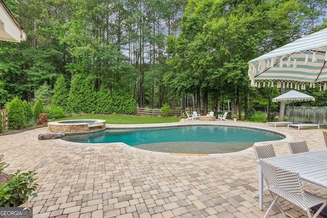 5095 Karr Rd, Cumming, GA 30040 - view of swimming pool with a patio area, a pool with connected hot tub, and view of wooded area