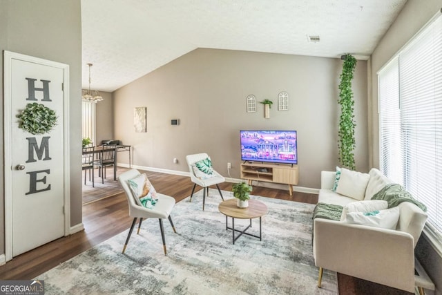 447 Sherwood Cir, Stone Mountain, GA 30087 - living area featuring a chandelier, wood finished floors, and vaulted ceiling
