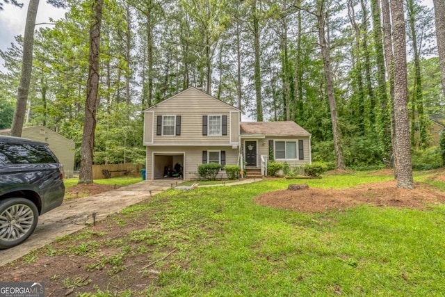 447 Sherwood Cir, Stone Mountain, GA 30087 - split level home featuring an attached garage, concrete driveway, and a front yard