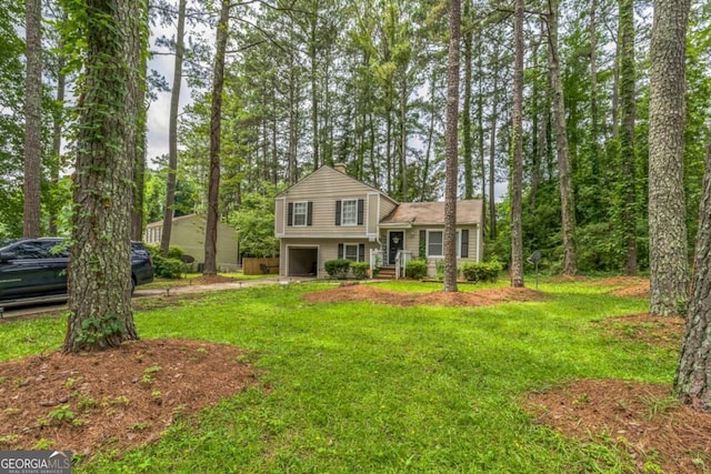 447 Sherwood Cir, Stone Mountain, GA 30087 - split level home with an attached garage, driveway, and a front yard