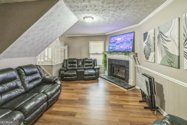 447 Sherwood Cir, Stone Mountain, GA 30087 - living area featuring a fireplace, wood finished floors, plenty of natural light, a textured ceiling, and ornamental molding