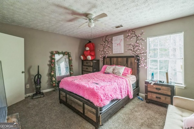 447 Sherwood Cir, Stone Mountain, GA 30087 - carpeted bedroom with a textured ceiling and a ceiling fan