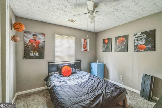 447 Sherwood Cir, Stone Mountain, GA 30087 - carpeted bedroom with a textured ceiling and a ceiling fan