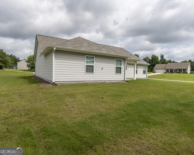 11 Rachel Ln, Hartwell, GA 30643 - back of house with a lawn and roof with shingles