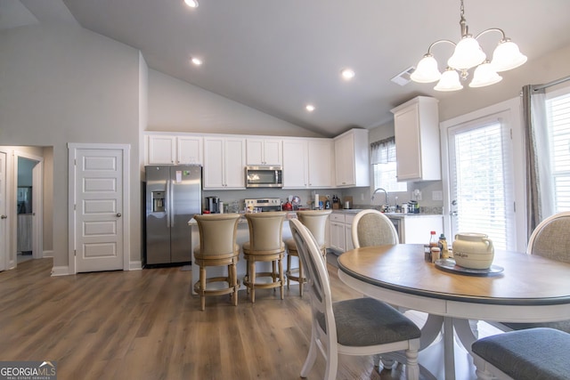 11 Rachel Ln, Hartwell, GA 30643 - dining space with a chandelier, dark wood-type flooring, high vaulted ceiling, and recessed lighting
