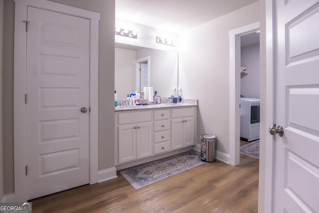 11 Rachel Ln, Hartwell, GA 30643 - bathroom featuring washer / clothes dryer, double vanity, and wood finished floors