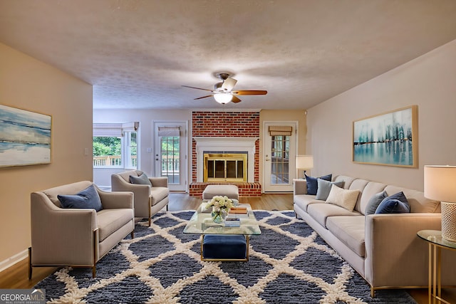 120 Fox Hunt Pl, Athens, GA 30606 - living room featuring ceiling fan, wood finished floors, and a brick fireplace