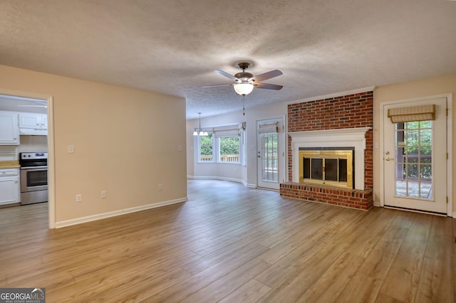 120 Fox Hunt Pl, Athens, GA 30606 - unfurnished living room with light wood-type flooring, a ceiling fan, a textured ceiling, and a fireplace