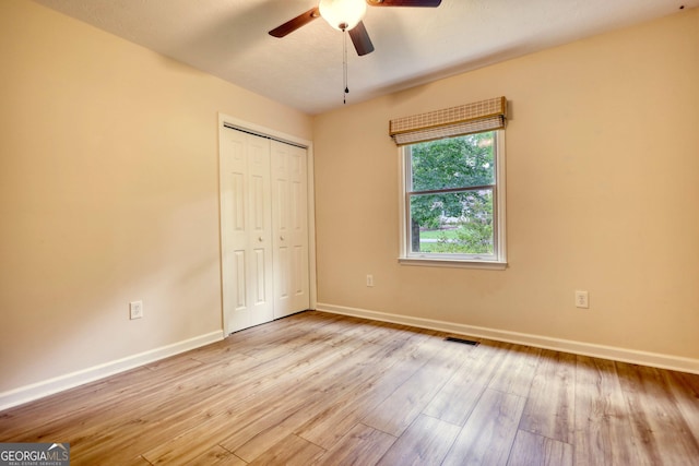 120 Fox Hunt Pl, Athens, GA 30606 - unfurnished bedroom featuring a closet, wood finished floors, and a ceiling fan