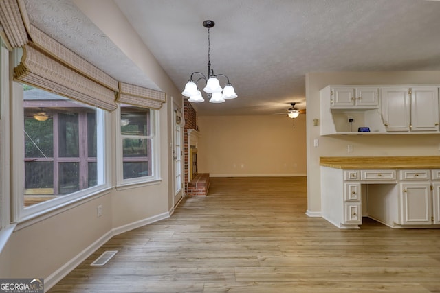 120 Fox Hunt Pl, Athens, GA 30606 - kitchen with a ceiling fan, a chandelier, decorative light fixtures, light wood-style flooring, and white cabinetry