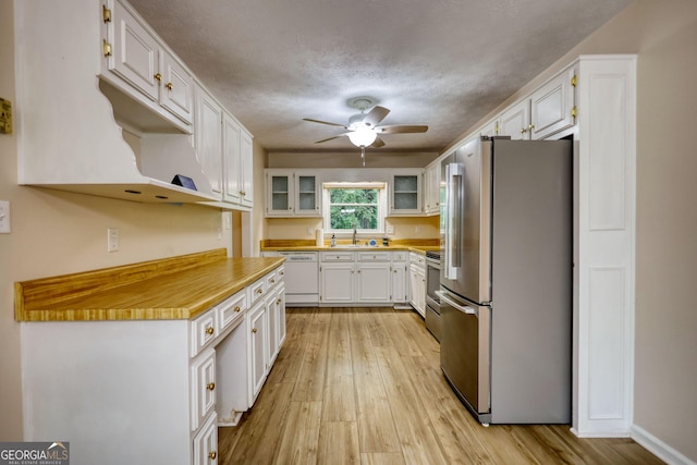 120 Fox Hunt Pl, Athens, GA 30606 - kitchen with appliances with stainless steel finishes, ceiling fan, light wood-style floors, white cabinets, and a textured ceiling