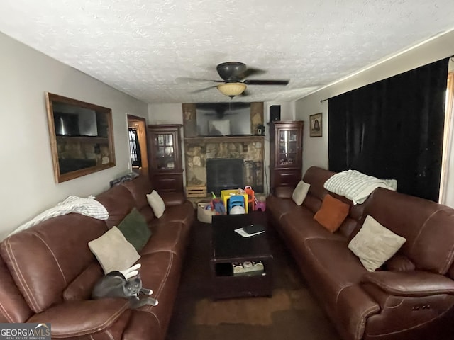 1791 Little Fawn Trl NW, Conyers, GA 30012 - living room featuring a stone fireplace, ceiling fan, and a textured ceiling