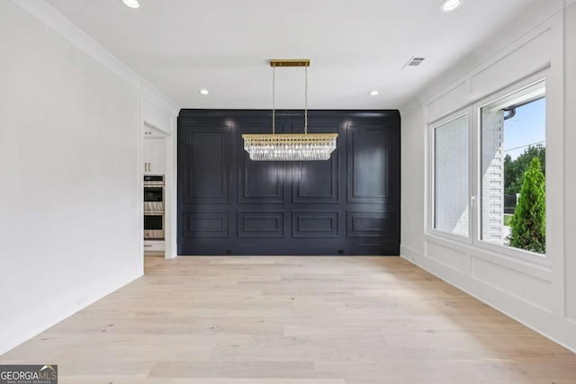 3205 Bold Springs Rd, Dacula, GA 30019 - unfurnished dining area featuring light wood finished floors, a decorative wall, recessed lighting, and a chandelier