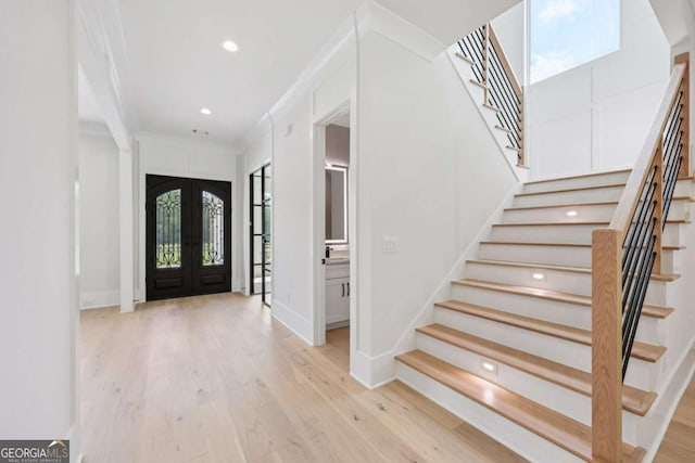 3205 Bold Springs Rd, Dacula, GA 30019 - foyer entrance with french doors, stairway, wood finished floors, recessed lighting, and crown molding
