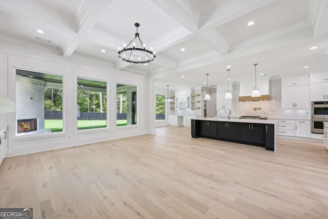 3205 Bold Springs Rd, Dacula, GA 30019 - unfurnished living room with a chandelier, coffered ceiling, light wood-style flooring, beam ceiling, and recessed lighting