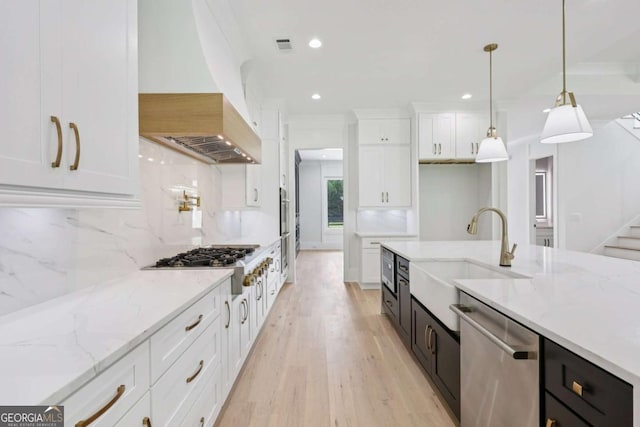 3205 Bold Springs Rd, Dacula, GA 30019 - kitchen featuring stainless steel appliances, white cabinets, tasteful backsplash, light wood-style flooring, and custom range hood