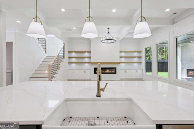 3205 Bold Springs Rd, Dacula, GA 30019 - kitchen featuring a glass covered fireplace, an island with sink, recessed lighting, beamed ceiling, and coffered ceiling