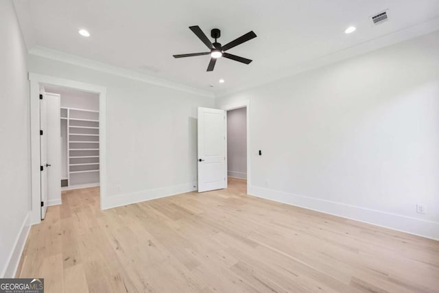3205 Bold Springs Rd, Dacula, GA 30019 - unfurnished bedroom with a walk in closet, ornamental molding, light wood-style flooring, recessed lighting, and a closet