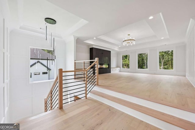 3205 Bold Springs Rd, Dacula, GA 30019 - corridor with an upstairs landing, a tray ceiling, a chandelier, wood finished floors, and recessed lighting