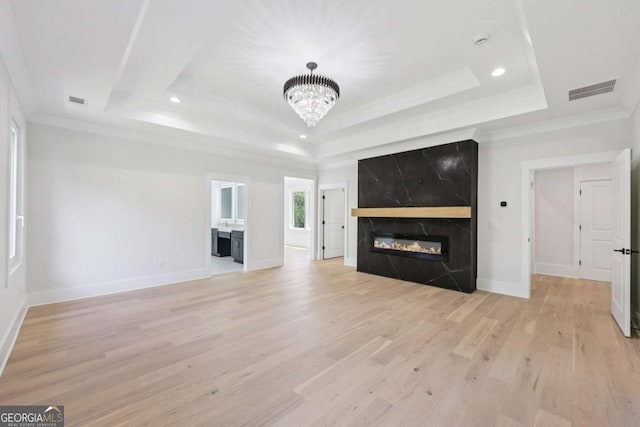 3205 Bold Springs Rd, Dacula, GA 30019 - unfurnished living room with a raised ceiling, a premium fireplace, a chandelier, light wood-style floors, and recessed lighting