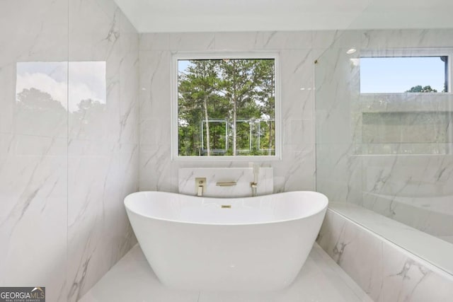 3205 Bold Springs Rd, Dacula, GA 30019 - full bath featuring tile walls, a freestanding tub, and healthy amount of natural light